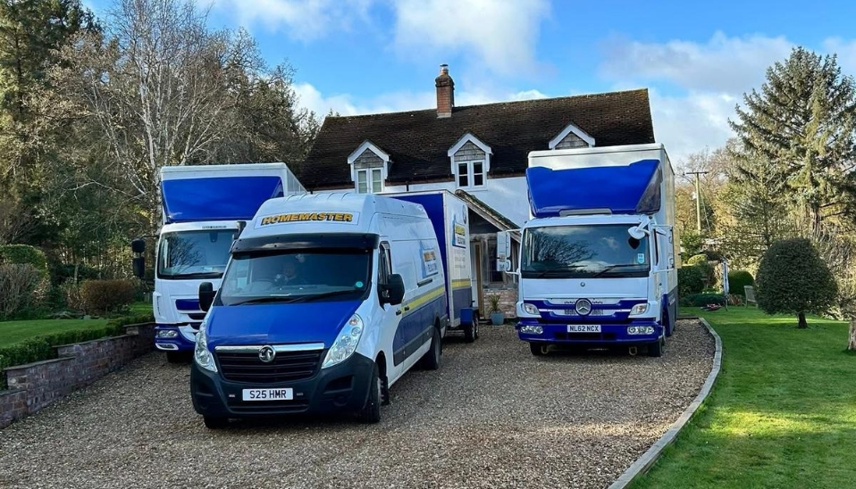 Homemaster Relocations vans and removal trucks at a client location, an image used for the blog '5 reasons homemaster relocations is the most reliable removals company in Shropshire'